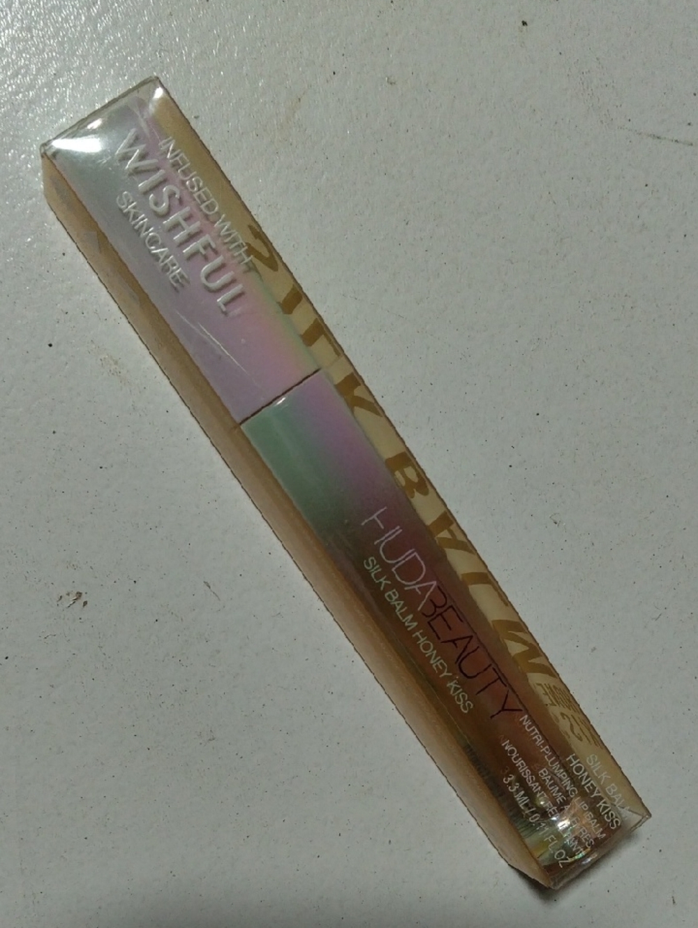 HUDA BEAUTY Silk Balm Honey Kiss - Iridescent Pink Green Tube with Gold Accents